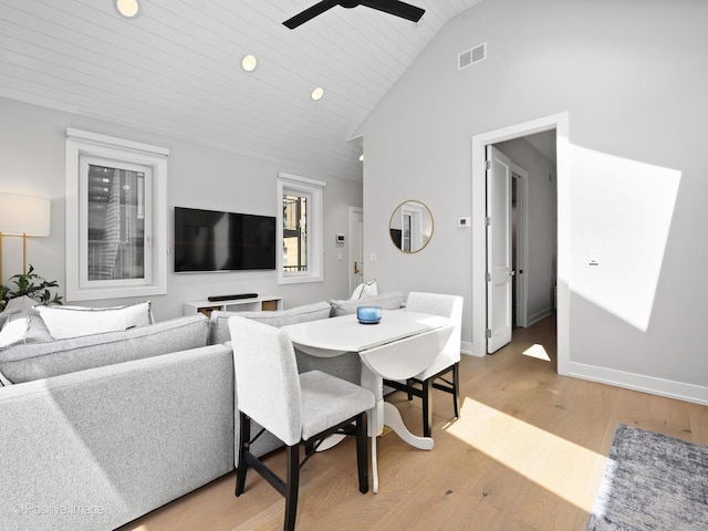 dining space featuring light wood-type flooring, vaulted ceiling, ceiling fan, recessed lighting, and baseboards