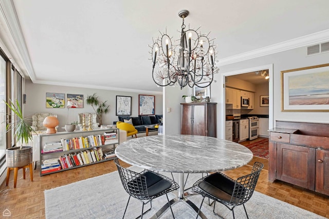 dining room with crown molding and a chandelier