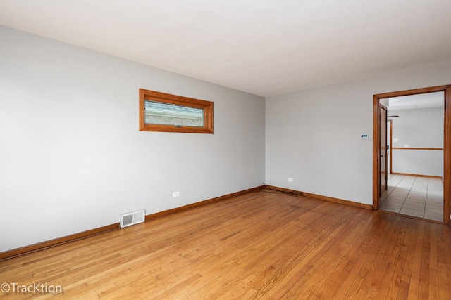 unfurnished room featuring light wood finished floors and baseboards