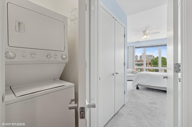 2700 N Halsted St Unit 406, Chicago, IL 60614 - washroom featuring stacked washer / drying machine, light colored carpet, a ceiling fan, and a view of city