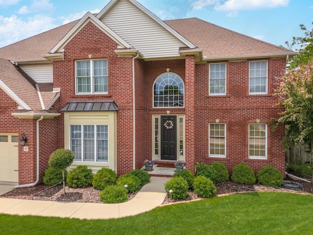 6 Conway Cir, Bloomington, IL 61704 - view of front facade with brick siding, a front yard, an attached garage, and roof with shingles