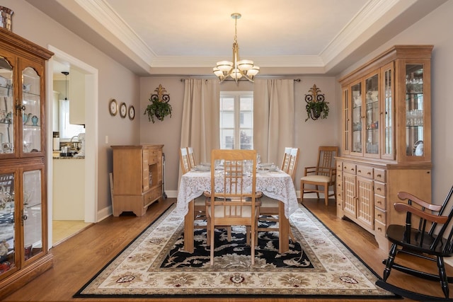 6 Conway Cir, Bloomington, IL 61704 - dining area featuring a chandelier, a raised ceiling, wood finished floors, and crown molding