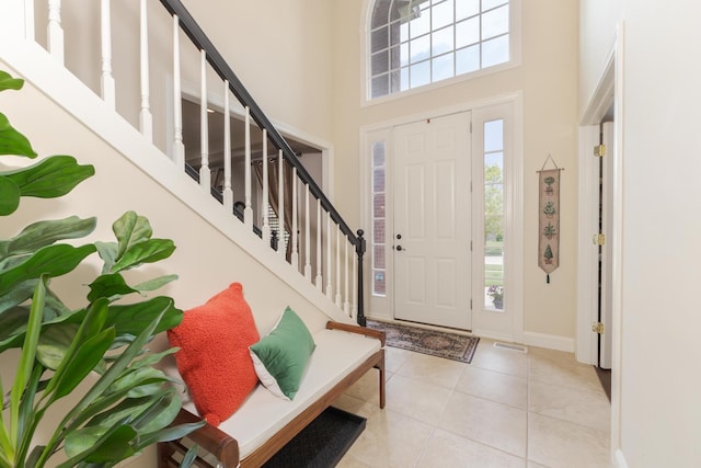 6 Conway Cir, Bloomington, IL 61704 - tiled entryway featuring plenty of natural light, a high ceiling, stairway, and baseboards
