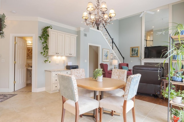 6 Conway Cir, Bloomington, IL 61704 - dining area featuring ceiling fan, crown molding, a chandelier, light tile patterned floors, and baseboards