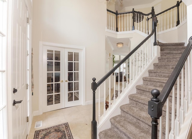 6 Conway Cir, Bloomington, IL 61704 - tiled entrance foyer featuring french doors, baseboards, a high ceiling, and stairs
