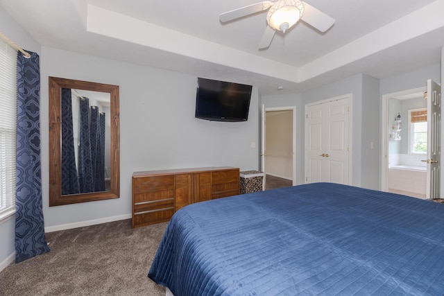 6 Conway Cir, Bloomington, IL 61704 - bedroom featuring a tray ceiling, carpet floors, baseboards, ceiling fan, and ensuite bath