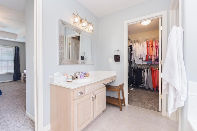 6 Conway Cir, Bloomington, IL 61704 - full bathroom featuring vanity, a spacious closet, baseboards, and tile patterned flooring