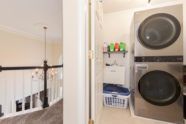 6 Conway Cir, Bloomington, IL 61704 - laundry area with stacked washing machine and dryer, a chandelier, tile patterned floors, and ornamental molding