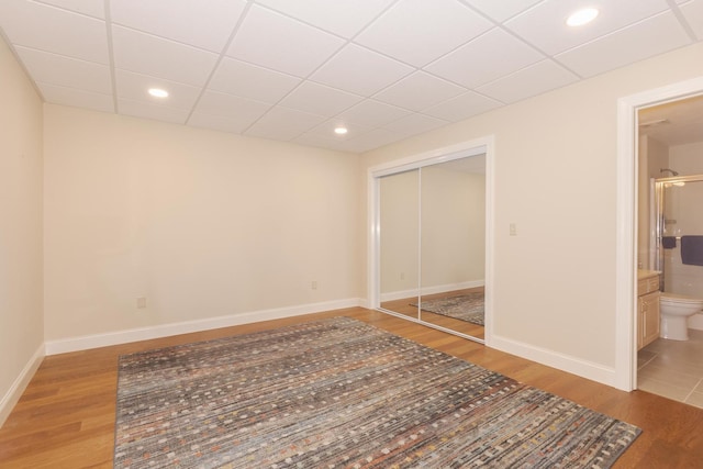 6 Conway Cir, Bloomington, IL 61704 - unfurnished bedroom with light wood-style flooring, a closet, baseboards, a paneled ceiling, and recessed lighting