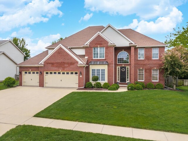 6 Conway Cir, Bloomington, IL 61704 - view of front of house with an attached garage, a front lawn, concrete driveway, and brick siding