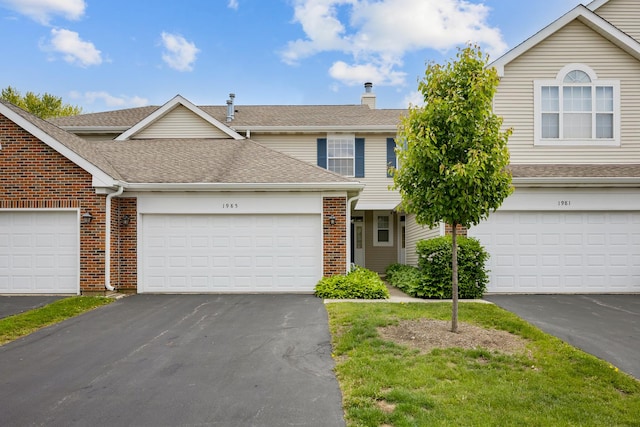1985 Blackberry Ln Unit 1985, Hoffman Estates, IL 60169 - traditional home with driveway, brick siding, a chimney, and roof with shingles