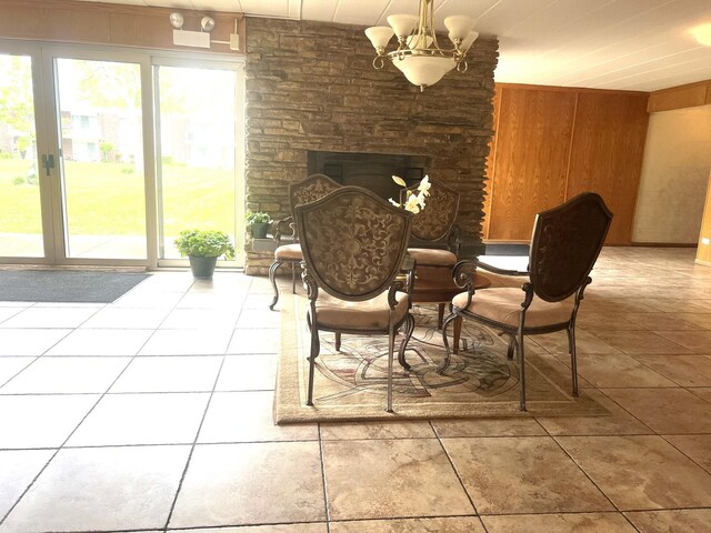 100 Deborah Ln Unit B35, Wheeling, IL 60090 - tiled dining area featuring plenty of natural light, a chandelier, wood walls, and a fireplace