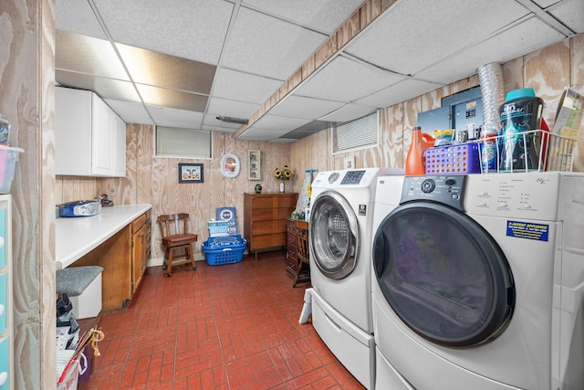 1723 Columbine Dr, Schaumburg, IL 60173 - laundry room with brick patterned floors, wooden walls, and independent washer and dryer