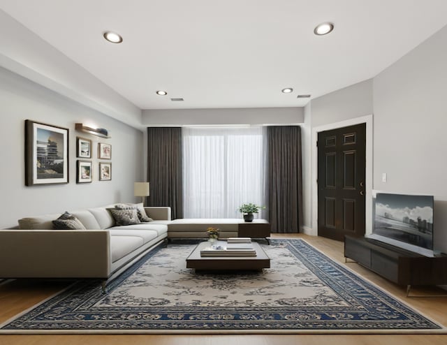 living area with recessed lighting and light wood finished floors