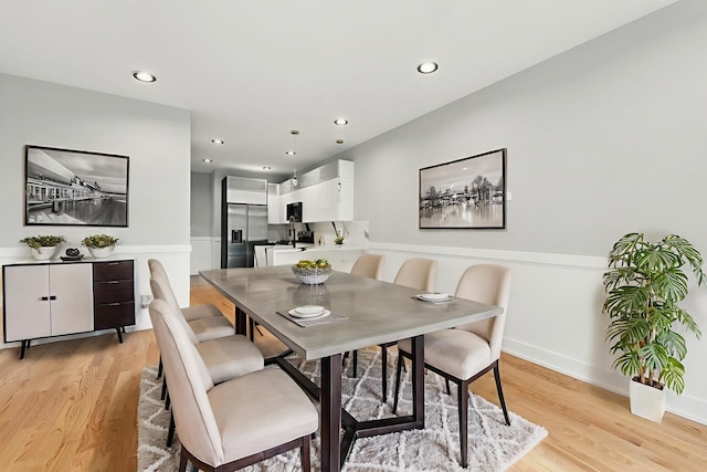 dining room with light wood finished floors and recessed lighting