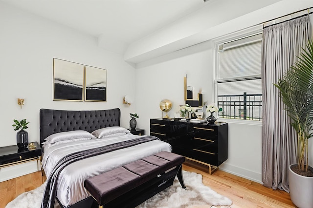 bedroom featuring wood finished floors and baseboards