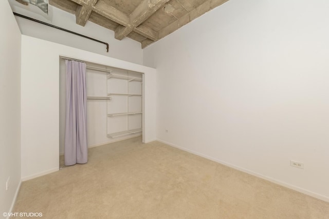 5200 S Ellis Ave Unit 211, Chicago, IL 60615 - unfurnished bedroom with carpet floors, a closet, baseboards, and beamed ceiling