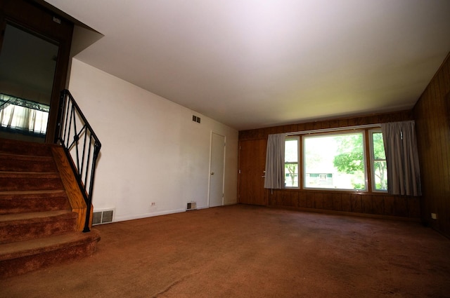 2876 S Scott St, Des Plaines, IL 60018 - unfurnished living room with stairs, carpet floors, and wood walls