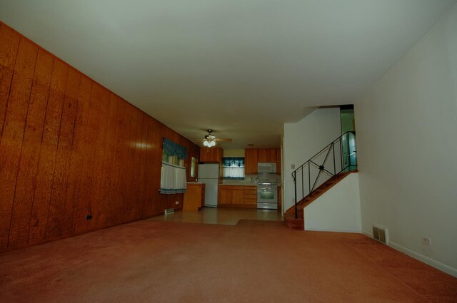 2876 S Scott St, Des Plaines, IL 60018 - unfurnished living room with a ceiling fan, stairway, carpet flooring, and wooden walls