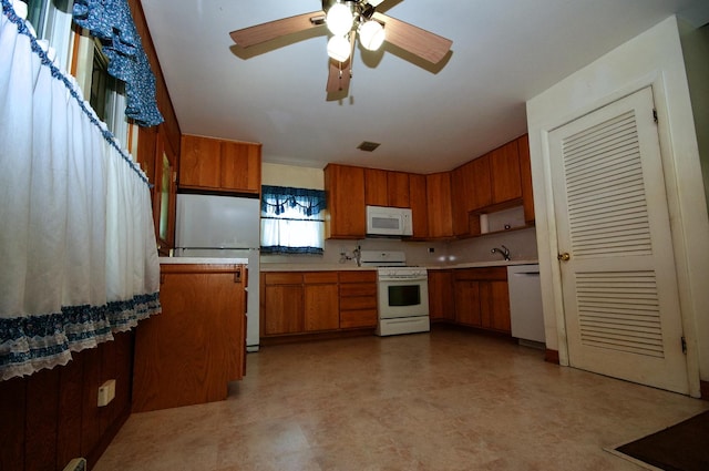 2876 S Scott St, Des Plaines, IL 60018 - kitchen featuring white appliances, brown cabinetry, light flooring, light countertops, and ceiling fan