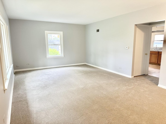 301 Illinois Ave, Elgin, IL 60120 - carpeted empty room with a sink and baseboards