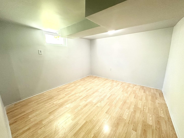 301 Illinois Ave, Elgin, IL 60120 - below grade area with light wood finished floors and baseboards