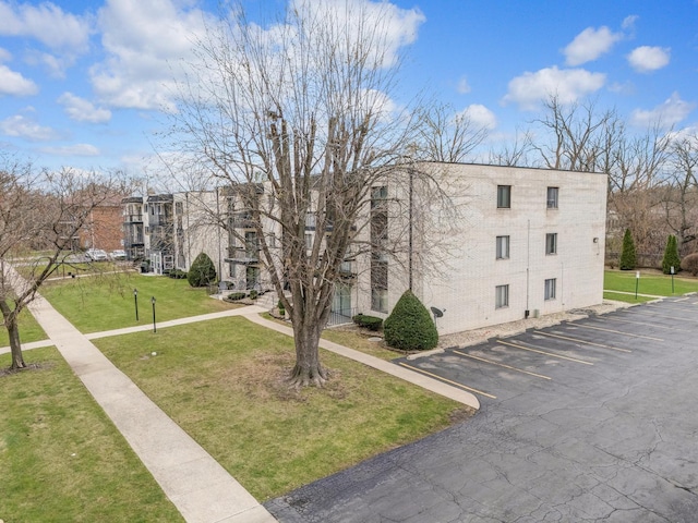 view of apartment building / complex featuring uncovered parking