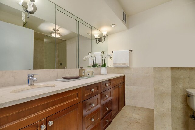 1212 N Lake Shore Dr Unit 12Cn, Chicago, IL 60610 - bathroom with vanity, tile walls, a shower with door, toilet, and tile patterned floors