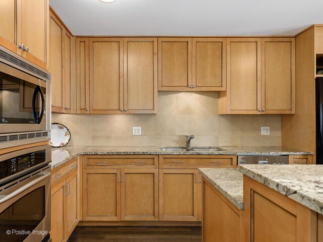 1212 N Lake Shore Dr Unit 12Cn, Chicago, IL 60610 - kitchen featuring stainless steel appliances, a sink, decorative backsplash, and light stone counters
