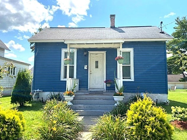bungalow-style house featuring a chimney
