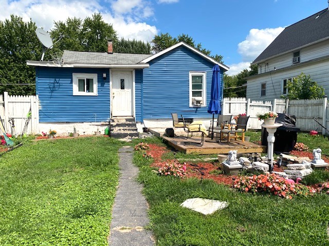 view of front of property featuring entry steps and a chimney