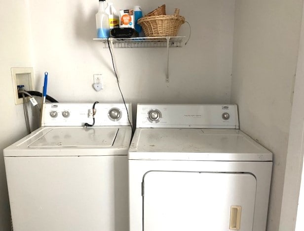 clothes washing area with washing machine and dryer