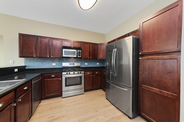 6420 Double Eagle Dr Unit 512, Woodridge, IL 60517 - kitchen featuring stainless steel appliances, dark countertops, light wood finished floors, tasteful backsplash, and a sink