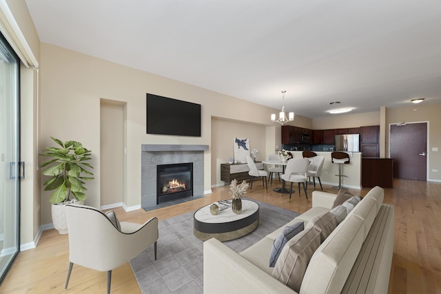6420 Double Eagle Dr Unit 512, Woodridge, IL 60517 - living area with a chandelier, light wood-style floors, a fireplace, and baseboards