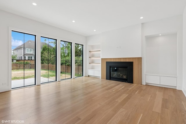 613 S Chatham Ave, Elmhurst, IL 60126 - unfurnished living room featuring built in features, light wood-style floors, recessed lighting, and a glass covered fireplace