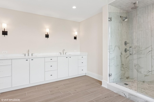 613 S Chatham Ave, Elmhurst, IL 60126 - bathroom featuring a marble finish shower, wood finish floors, baseboards, a sink, and recessed lighting
