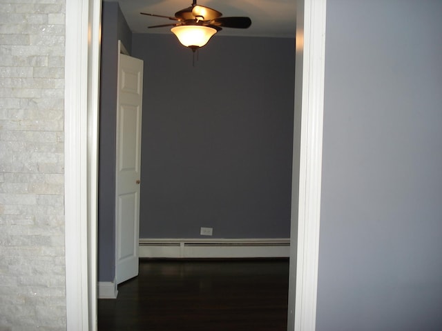 hall with a baseboard radiator and wood finished floors