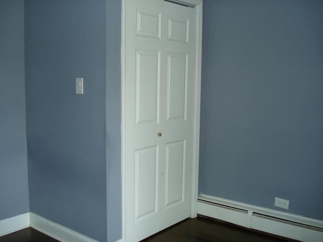 spare room with a baseboard heating unit and baseboards