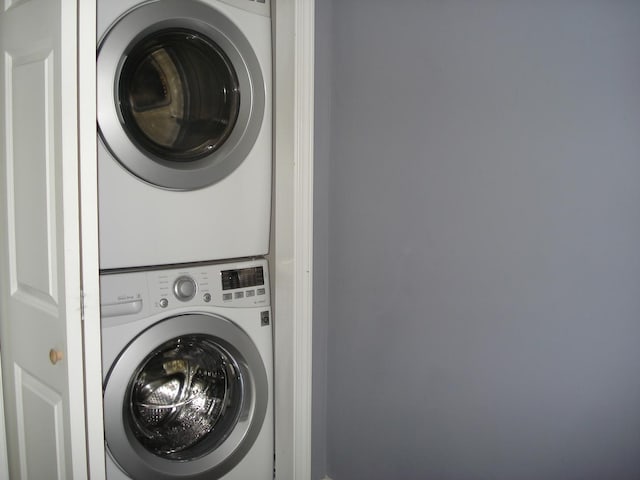 laundry area with stacked washing machine and dryer