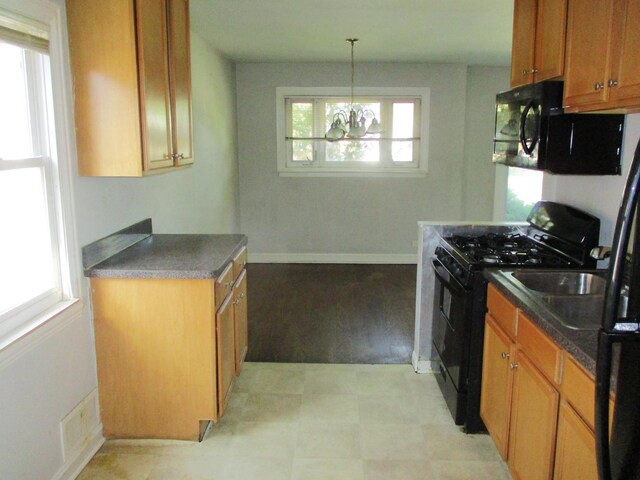 9029 S Crandon Ave, Chicago, IL 60617 - kitchen featuring black appliances, a chandelier, brown cabinets, and dark countertops