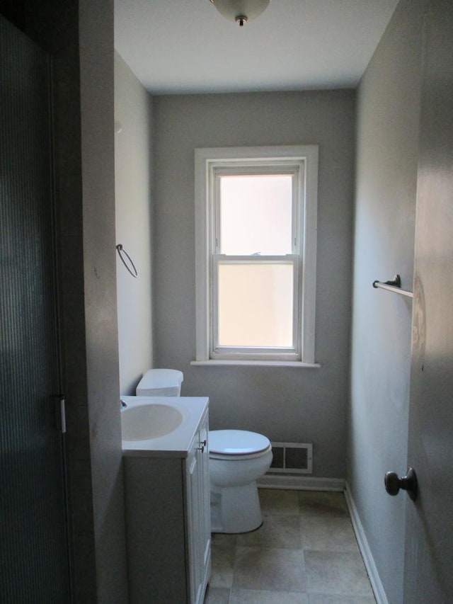 9029 S Crandon Ave, Chicago, IL 60617 - bathroom featuring toilet, vanity, and baseboards