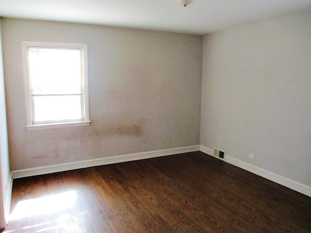 9029 S Crandon Ave, Chicago, IL 60617 - empty room featuring dark wood-style floors and baseboards