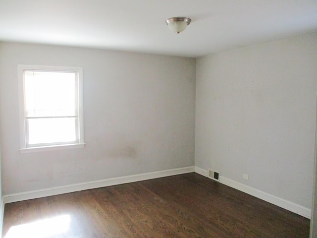 9029 S Crandon Ave, Chicago, IL 60617 - unfurnished room featuring dark wood-style flooring and baseboards
