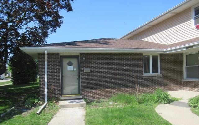 entrance to property with brick siding