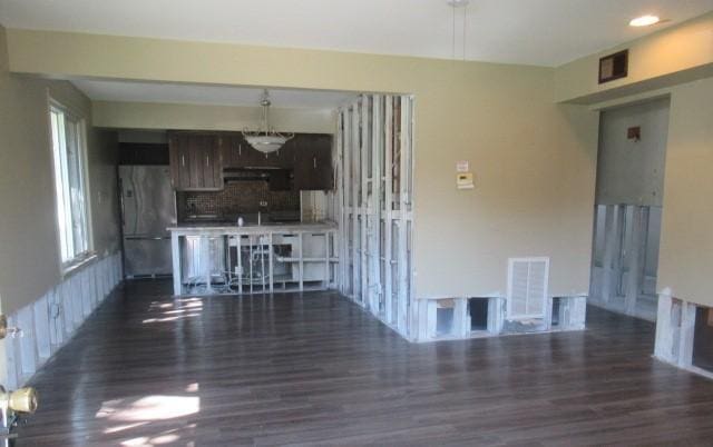 unfurnished living room with wood finished floors