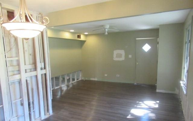 unfurnished room with wood finished floors, ceiling fan, and baseboards