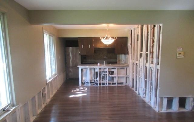 kitchen with freestanding refrigerator and wood finished floors