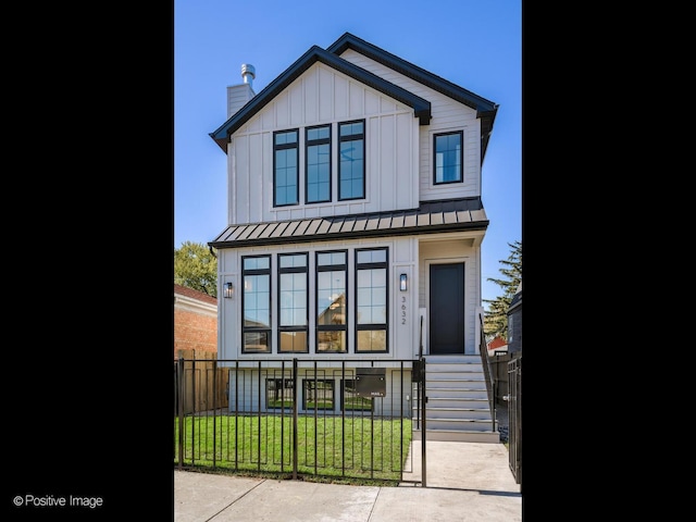 2535 W Belden Ave, Chicago, IL 60647 - view of front of house featuring board and batten siding, a standing seam roof, a chimney, and metal roof