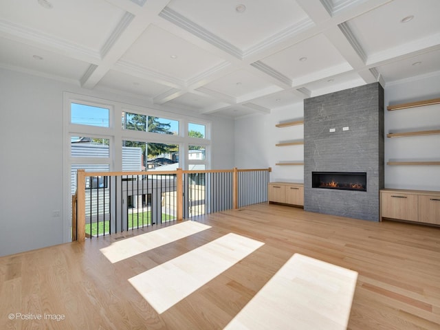 2535 W Belden Ave, Chicago, IL 60647 - unfurnished living room with light wood finished floors, a fireplace, beamed ceiling, and coffered ceiling