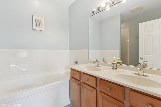 bathroom with a bath, double vanity, and a shower